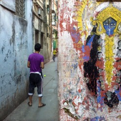 Cricket in the alley and mural of goddess Kali, Near Shyambazar, 2011